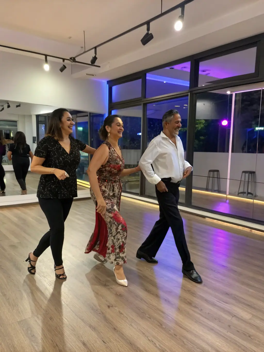 A group of people in a swing dance class, smiling and laughing as they learn a new step, with an instructor demonstrating the move in front of them, set in a brightly lit dance studio with wooden floors.